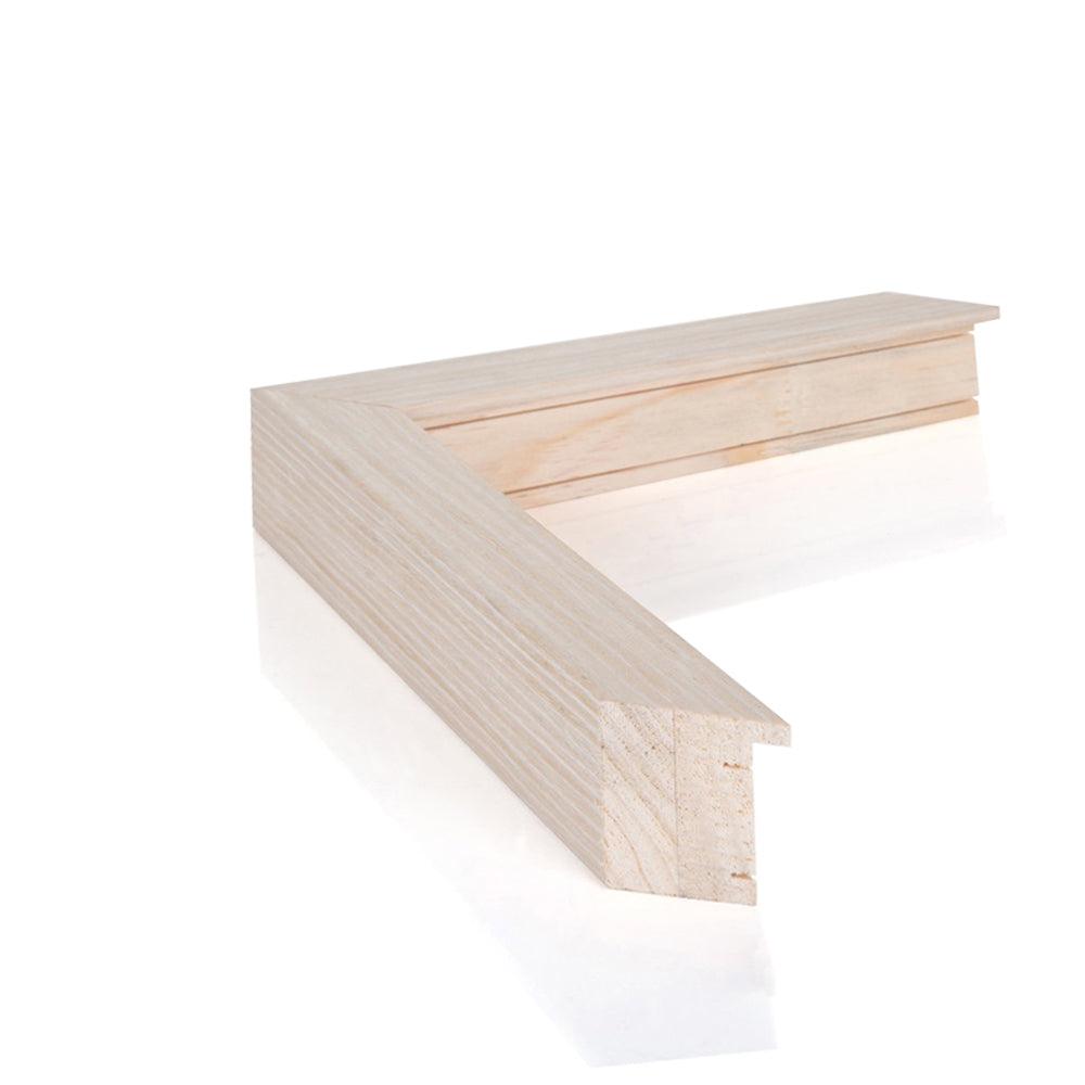 a wooden bench sitting in front of a white wall 