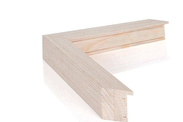 a wooden bench sitting in front of a white wall 